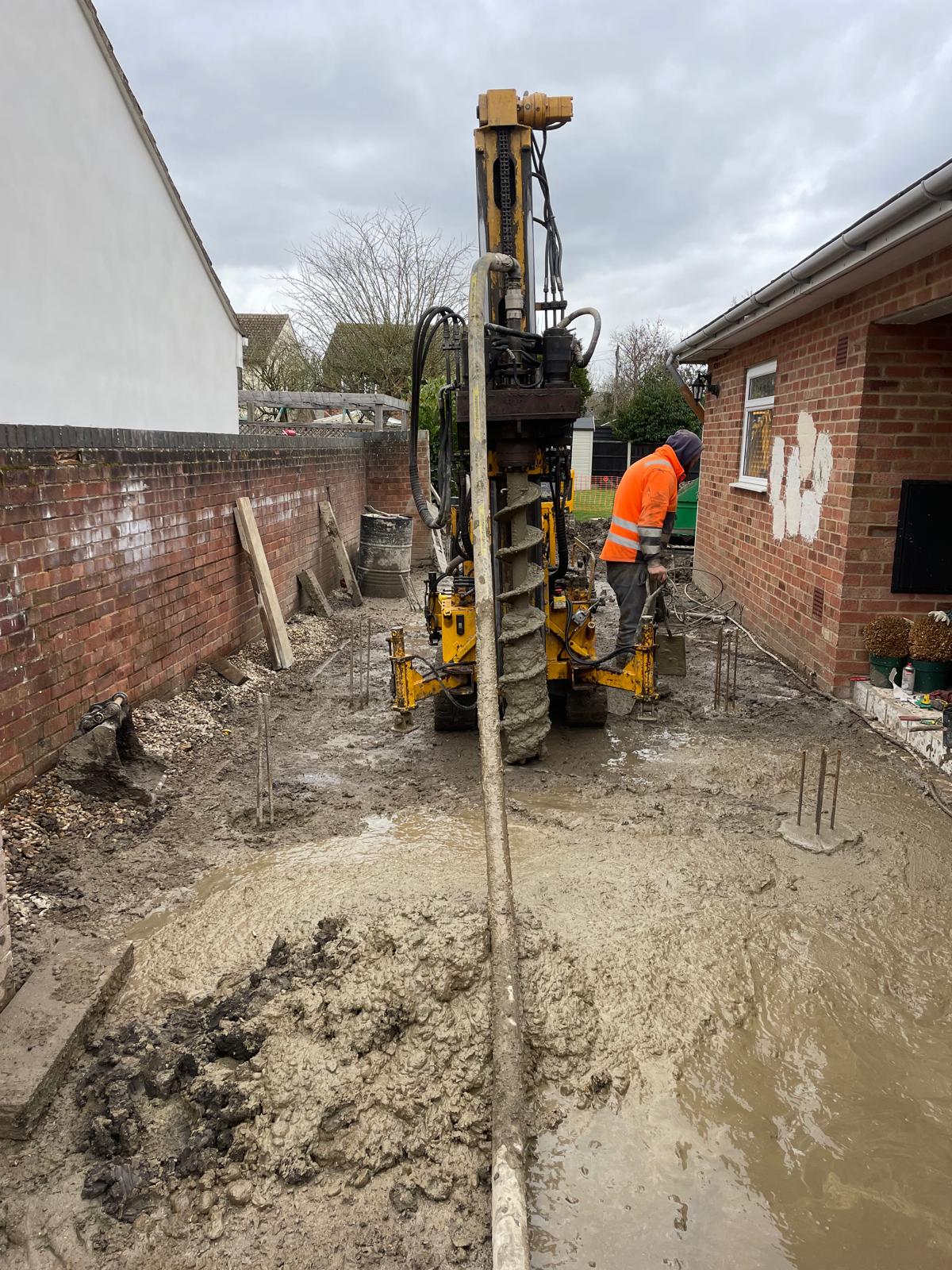 CFA piling rig installing a continuous flight auger pile in a restricted residential side access
